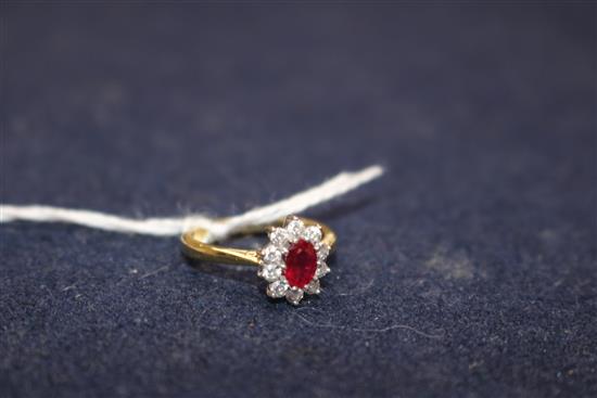 A modern 18ct gold, ruby and diamond cluster ring, size L.